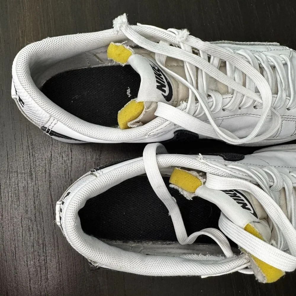 Nike White Leather Low-Top Sneakers with Black Swoosh and Yellow Tongue
